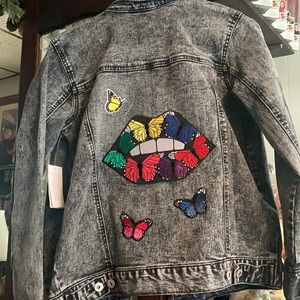 NWT….One of a kind.Unique black acid wash Jean jacket Custom patch work on back